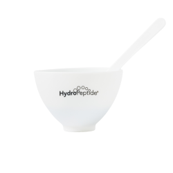 A white silicone bowl with a printed back Hydropeptide logo with a spatula sitting out the top on a white background